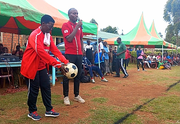 Nyamira County Executive Committee Member for Sports Dr Grace Nyamongo trying a ball used for Talanta Hela trials